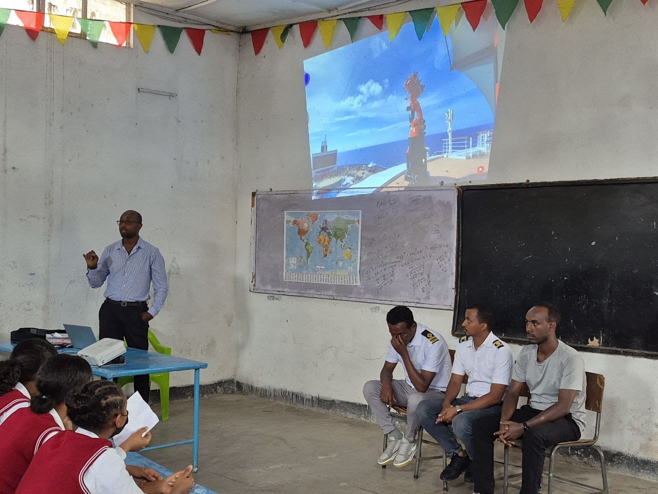 A man giving a presentation in front of a class.