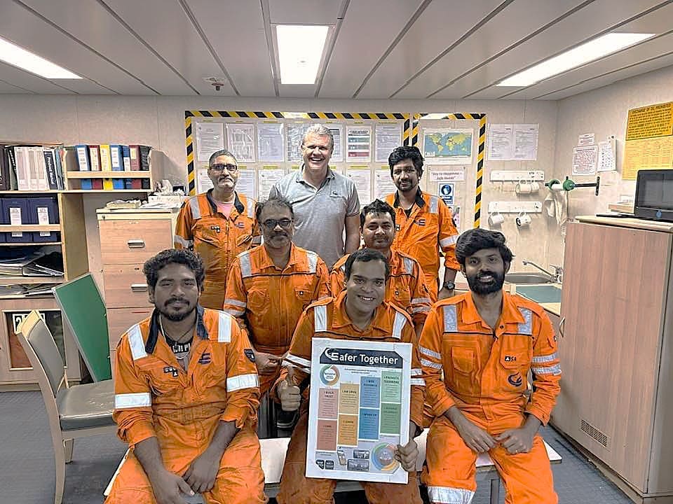 The engineering crew of seafarers together in a group.