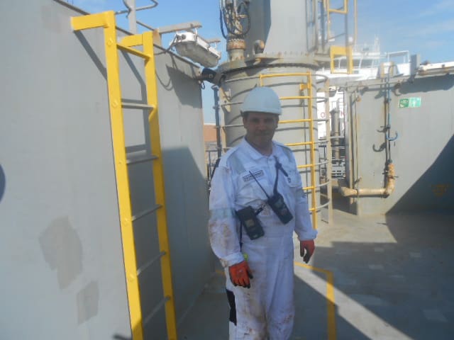 Man in safety uniform onboard vessel