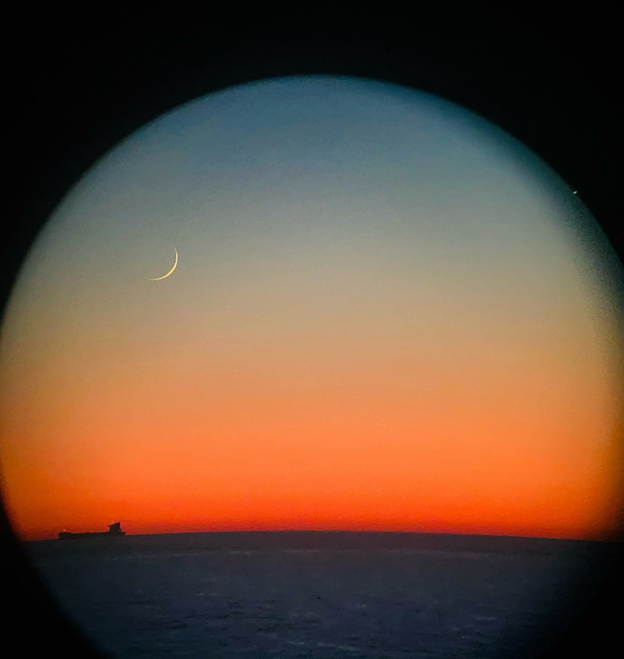 Sunset seen through binocular lens