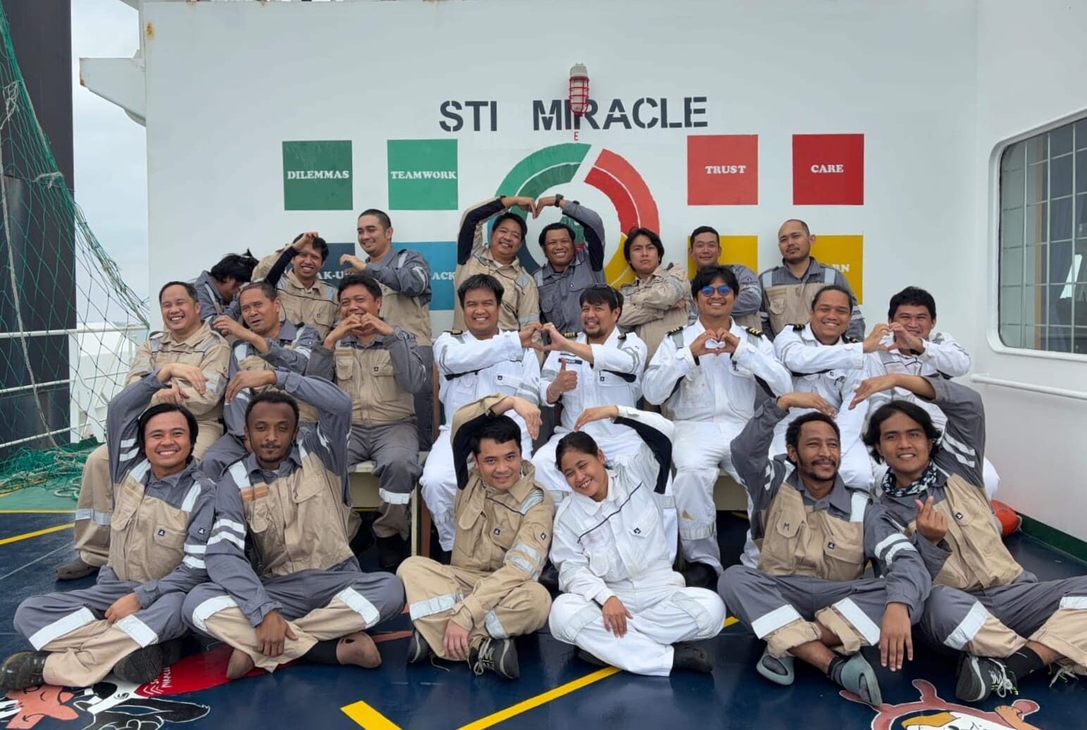 Group of seafarers posing onboard a vessel