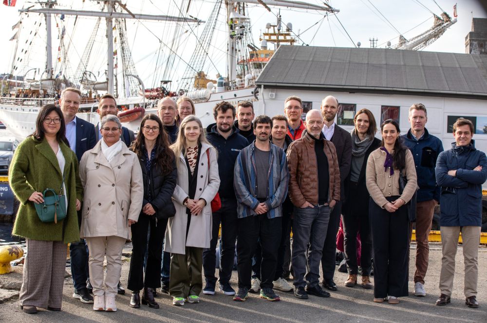 Group photo of people standing by the port in Bergen, Norway