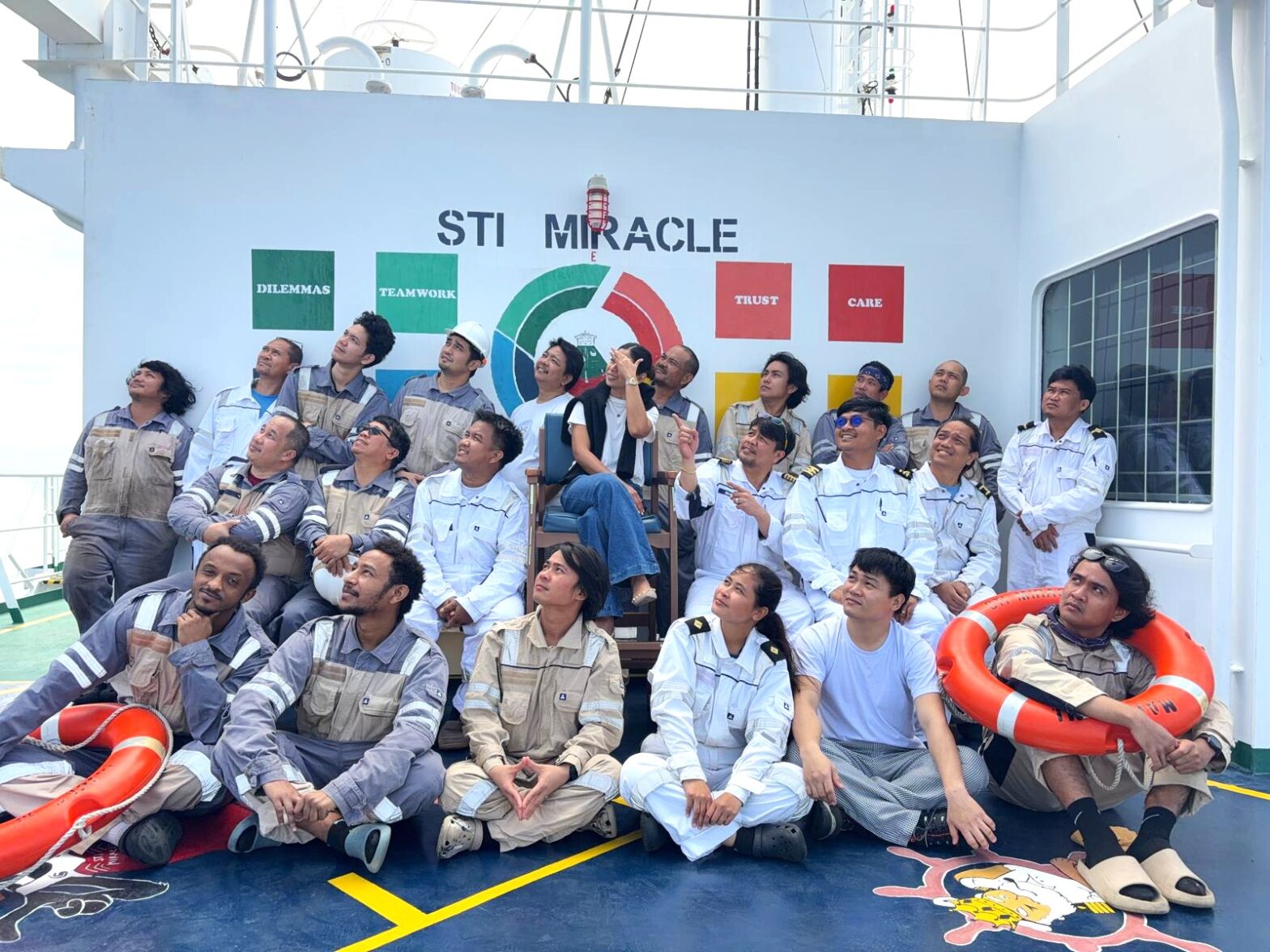 Group of seafarers onboard a ship, posing together.