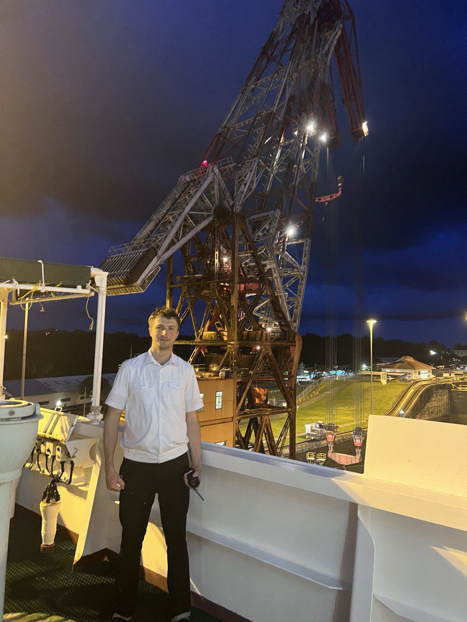 Captain on the deck in front of large crane
